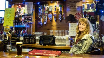 Bartender smiling at The Corner House in Rathdrum, Ireland. © 2016 Nicholas Orloff